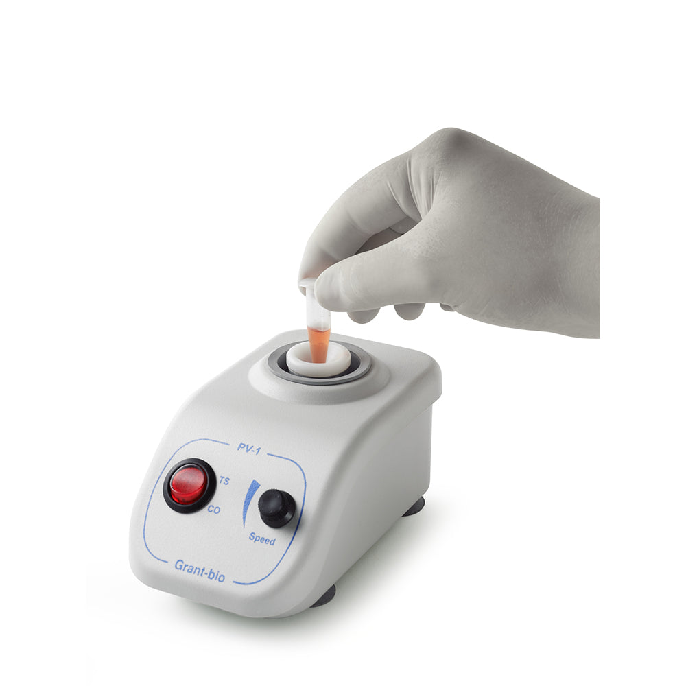 White gloved hand putting a sample tube on a small white vortex mixer