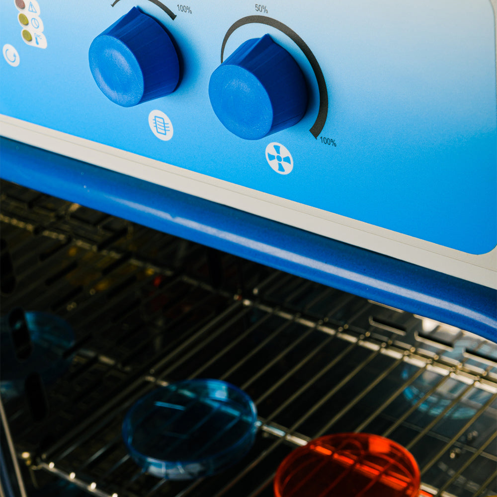 Close up of incubator with two blue knobs
